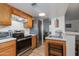 Modern kitchen with stainless steel appliances, ample counter space, and bright lighting enhances cooking experience at 12123 W Bell Rd # 219, Surprise, AZ 85378