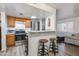 Well-lit kitchen features stainless steel appliances, a breakfast bar, and modern cabinetry near living space at 12123 W Bell Rd # 219, Surprise, AZ 85378
