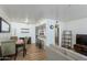 Open-concept living space featuring wood-look floors, dining area, breakfast bar and stainless steel appliances at 12123 W Bell Rd # 219, Surprise, AZ 85378