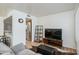 Bright living room with wood-look floors, neutral walls, and comfortable seating near modern entertainment center at 12123 W Bell Rd # 219, Surprise, AZ 85378