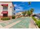 Shuffleboard court surrounded by landscaping and palm trees in a well-kept community at 12123 W Bell Rd # 219, Surprise, AZ 85378
