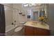 A well-lit bathroom with a shower-tub combo and single sink vanity beneath a well lit mirror at 12826 W La Vina Dr, Sun City West, AZ 85375