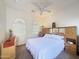 A bright bedroom with a bed, dresser, and arched windows, illuminated by a ceiling fan at 12826 W La Vina Dr, Sun City West, AZ 85375