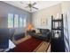 A versatile room set up as a home office, featuring a sofa, desk, and comfortable chair at 12826 W La Vina Dr, Sun City West, AZ 85375
