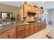 Well-appointed kitchen featuring granite countertops, custom cabinetry, a gas cooktop, and modern appliances at 12826 W La Vina Dr, Sun City West, AZ 85375