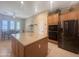 Spacious kitchen featuring a central island with granite countertops, stainless steel appliances, and ample storage space at 12826 W La Vina Dr, Sun City West, AZ 85375