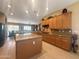 Bright and open kitchen layout with an island, tiled floors, and abundant cabinet space, seamlessly flowing into the dining area at 12826 W La Vina Dr, Sun City West, AZ 85375