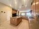 Large kitchen area featuring an island, stainless steel appliances, plenty of lighting, and seamless transition to the living areas at 12826 W La Vina Dr, Sun City West, AZ 85375