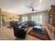 Spacious living room with comfortable seating, a ceiling fan, and ample natural light, perfect for relaxation and gatherings at 12826 W La Vina Dr, Sun City West, AZ 85375