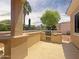Well-equipped outdoor kitchen has built-in grill, beverage fridge, and bar top for easy entertaining at 12826 W La Vina Dr, Sun City West, AZ 85375