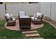 Outdoor patio set with four chairs on a brick surround in a well-maintained backyard at 14977 W Charter Oak Rd, Surprise, AZ 85379