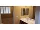 Bathroom featuring double sinks with vanity and window at 14977 W Charter Oak Rd, Surprise, AZ 85379