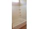 A pristine white bathtub and shower with built in shelves at 14977 W Charter Oak Rd, Surprise, AZ 85379