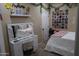 Stylish bedroom with a vanity, mirror, comfortable bed, and decorative wall art at 14977 W Charter Oak Rd, Surprise, AZ 85379