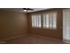 Spacious bedroom features tile floors and multiple windows with bright, modern shutters at 14977 W Charter Oak Rd, Surprise, AZ 85379