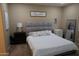Comfortable bedroom featuring carpet, a bed with a padded headboard, and neutral decor at 14977 W Charter Oak Rd, Surprise, AZ 85379