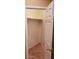 Walk-in closet featuring built-in shelving and carpeted floor at 14977 W Charter Oak Rd, Surprise, AZ 85379
