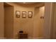 A cozy entryway nook with artwork and a wooden bench for added convenience at 14977 W Charter Oak Rd, Surprise, AZ 85379