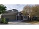 Charming single-story home showcasing a well-manicured front yard and a two-car garage at 14977 W Charter Oak Rd, Surprise, AZ 85379
