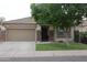 Charming single-story home featuring a manicured lawn and a welcoming two-car garage at 14977 W Charter Oak Rd, Surprise, AZ 85379