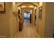 Arched hallway leading into a bright living space with visible neutral-toned decor at 14977 W Charter Oak Rd, Surprise, AZ 85379