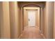 Inviting hallway with arched entryways featuring neutral color palette and tiled flooring at 14977 W Charter Oak Rd, Surprise, AZ 85379