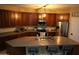Spacious kitchen featuring dark wood cabinetry, a large island, and modern appliances at 14977 W Charter Oak Rd, Surprise, AZ 85379