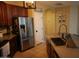 Kitchen with stainless steel appliances and dark wood cabinets at 14977 W Charter Oak Rd, Surprise, AZ 85379