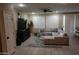 Cozy living room featuring a sectional sofa, plantation shutters, and neutral decor at 14977 W Charter Oak Rd, Surprise, AZ 85379