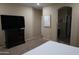 Bedroom with carpet, tv, dresser, and neutral decor at 14977 W Charter Oak Rd, Surprise, AZ 85379