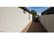 View of a gravel filled side yard with a block fence and the side of the home at 14977 W Charter Oak Rd, Surprise, AZ 85379