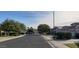 A neighborhood street view with mature landscaping and tree lined streets at 14977 W Charter Oak Rd, Surprise, AZ 85379