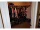 Walk-in closet features custom shelving and ample hanging space for clothes and shoes at 14977 W Charter Oak Rd, Surprise, AZ 85379