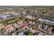 Aerial image featuring neighborhood homes near commercial areas, landscaped streets, and open fields at 15518 W Ocotillo Ln, Surprise, AZ 85374