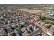 A serene aerial view of a residential area with private pools, green spaces, and neighborhood streets at 15518 W Ocotillo Ln, Surprise, AZ 85374