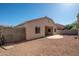 Expansive backyard features gravel, a concrete patio, and a block wall for added privacy at 15518 W Ocotillo Ln, Surprise, AZ 85374