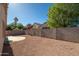 Large gravel backyard with patio, block wall, and view of mature trees at 15518 W Ocotillo Ln, Surprise, AZ 85374