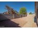 Low-maintenance backyard featuring a gravel landscape, concrete patio, and block wall at 15518 W Ocotillo Ln, Surprise, AZ 85374