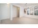 Bright dining room area featuring tiled floors, a modern chandelier, and natural light at 15518 W Ocotillo Ln, Surprise, AZ 85374