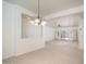 Open-concept dining area with tiled floors, modern lighting, and seamless living room access at 15518 W Ocotillo Ln, Surprise, AZ 85374