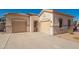 Charming single-story home with dual garages and a well-maintained desert landscape at 15518 W Ocotillo Ln, Surprise, AZ 85374