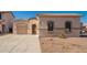 Inviting single-story house with dual garages and desert landscaping on a sunny day at 15518 W Ocotillo Ln, Surprise, AZ 85374