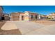 Attractive single-story house with dual garages, desert landscaping, and spacious driveway at 15518 W Ocotillo Ln, Surprise, AZ 85374