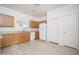 Traditional kitchen features wooden cabinets, white appliances, and neutral tiled floor at 15518 W Ocotillo Ln, Surprise, AZ 85374