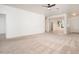 Open-concept living area with neutral carpet, white walls, and ample space for entertaining at 15518 W Ocotillo Ln, Surprise, AZ 85374