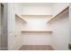 Spacious walk-in closet featuring carpet flooring and wooden shelving for optimal organization at 15518 W Ocotillo Ln, Surprise, AZ 85374
