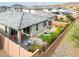 Aerial view of backyard featuring patio seating, desert landscaping, and privacy fence at 16551 W Winston Dr, Goodyear, AZ 85338