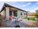 Outdoor living space offering a patio with seating and a meticulously landscaped backyard at 16551 W Winston Dr, Goodyear, AZ 85338