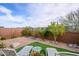 Landscaped backyard featuring artificial turf, desert plants, and patio furniture at 16551 W Winston Dr, Goodyear, AZ 85338