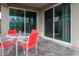 Cozy covered patio with outdoor seating, sliding glass doors, and brick pavers at 16551 W Winston Dr, Goodyear, AZ 85338